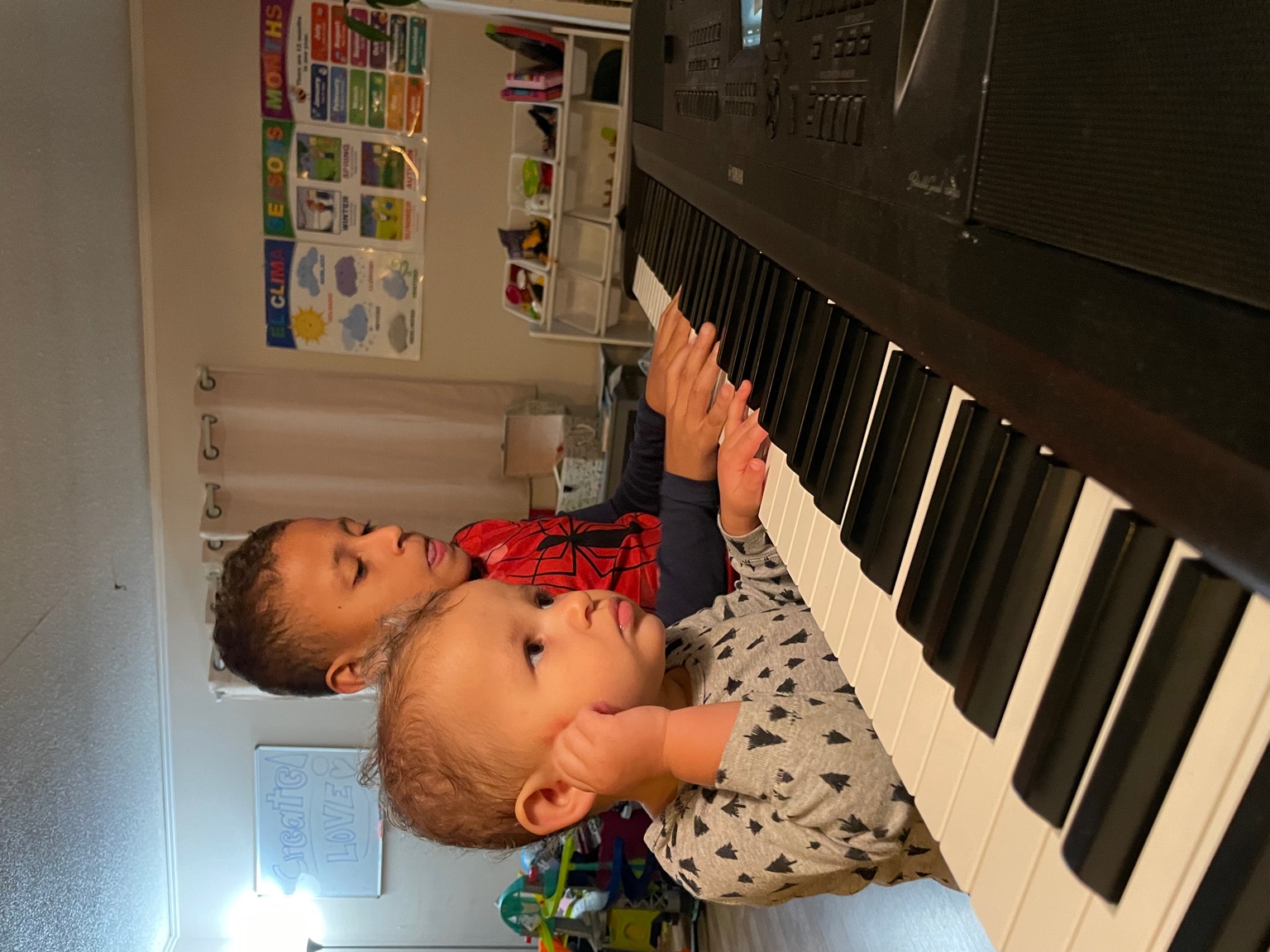 Leonardo playing piano with his sister